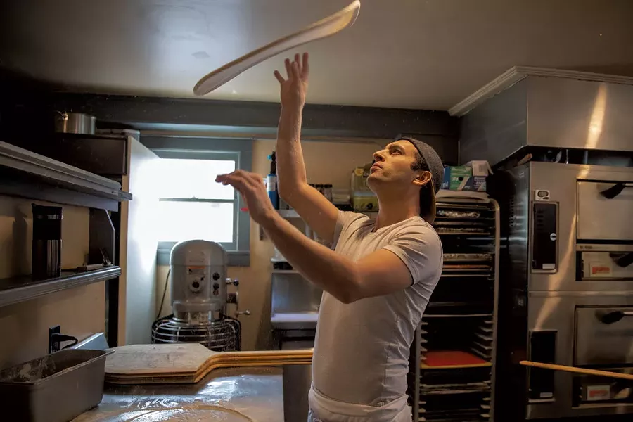 Co-owner Tyler Stratton tossing dough - JAMES BUCK