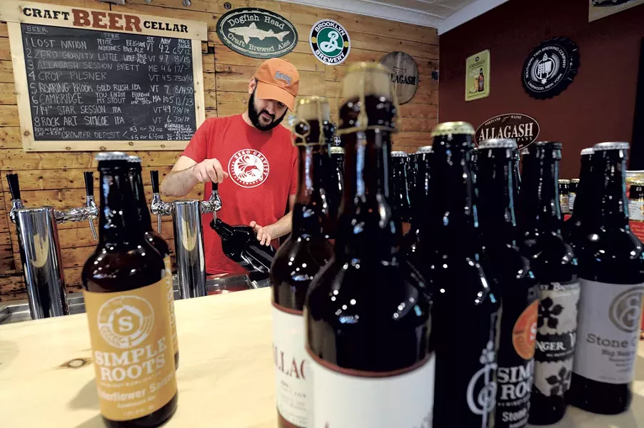 Mark Drutman fills a growler - JEB WALLACE-BRODEUR