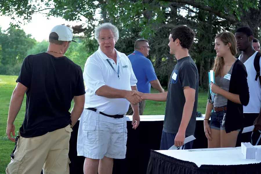 David Wolk greeting students at a barbecue on campus - TEARSA BRANNOCK
