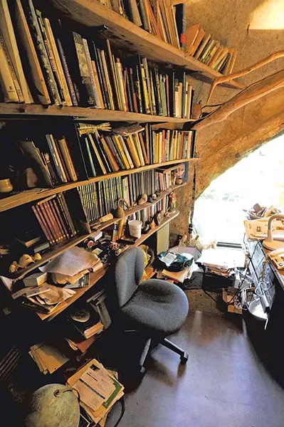 The main living room and loft , lit by rounded windows, contain mementos and artwork from Chappelle's travels. - JEB WALLACE-BRODEUR