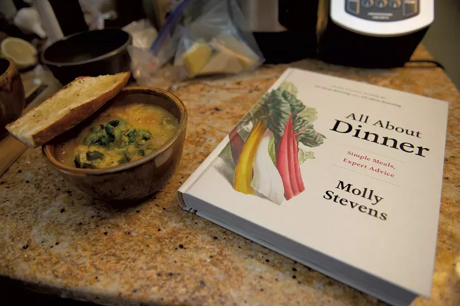 Vegetable-and-lentil soup alongside Molly Stevens' cookbook All About Dinner - DARIA BISHOP