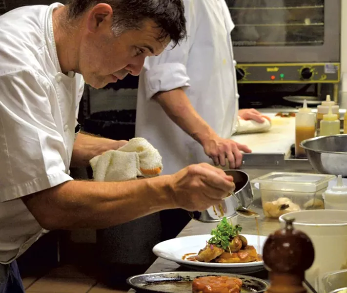 Herve Mahe plating food at Bistro de Margot - COURTESY OF HERVE MAHE