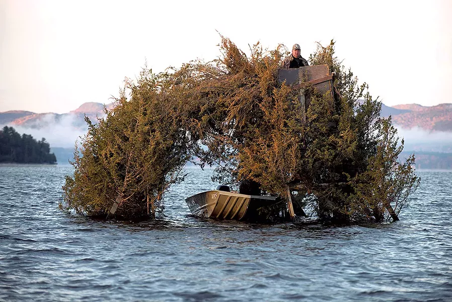 Hunter in a duck blind - CALEB KENNA