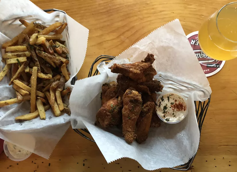 Dry-rubbed chicken wings and fries at St. Paul Street Gastrogrub - JORDAN BARRY