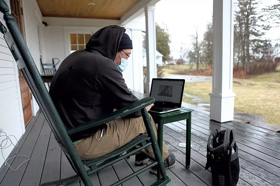 Mitch Hunt using the Wi-Fi outside of the Craftsbury library - KEVIN MCCALLUM