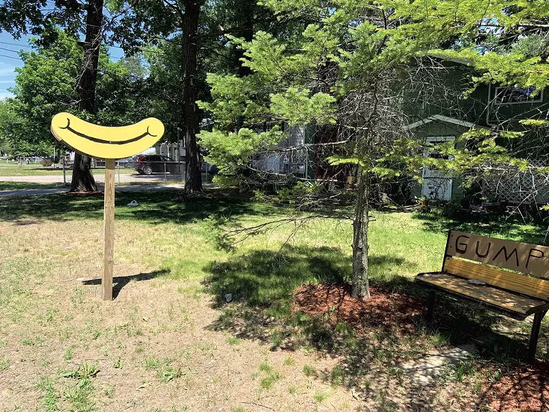 Grin sign and "GUMP" bench - KEN PICARD