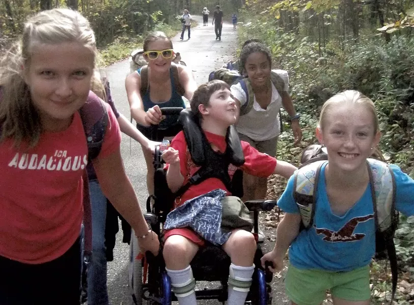 Middle school classmates helping Ben Wood-Lewis climb Mount Philo back in 2011