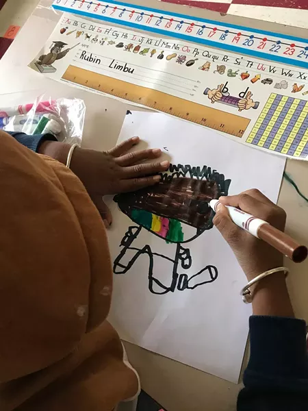 A student at JFK Elementary drawing a masked self-portrait - COURTESY OF THE WINOOSKI SCHOOL DISTRICT