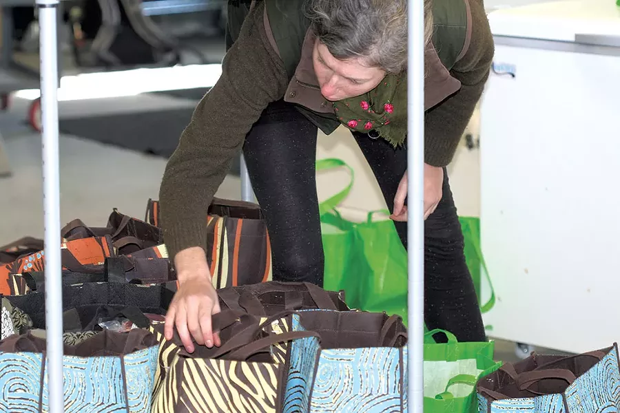 Leslie Ruster checking orders - SUZANNE PODHAIZER