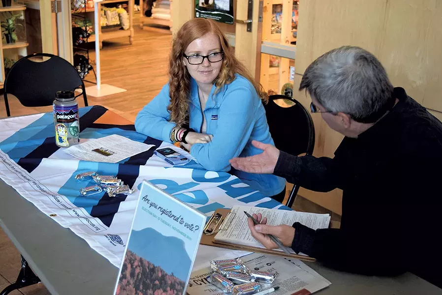 University of Vermont freshman Carolynn van Arsdale staffing a voter registration table with Andrew Champagne for the Vermont Democratic Party - TERRI HALLENBECK
