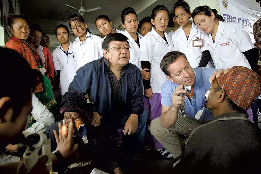 Doctors Sanduk Ruit and Geoff Tabin examining a cataract patient in Nepal - COURTESY OF MICHAEL AMENDOLIA