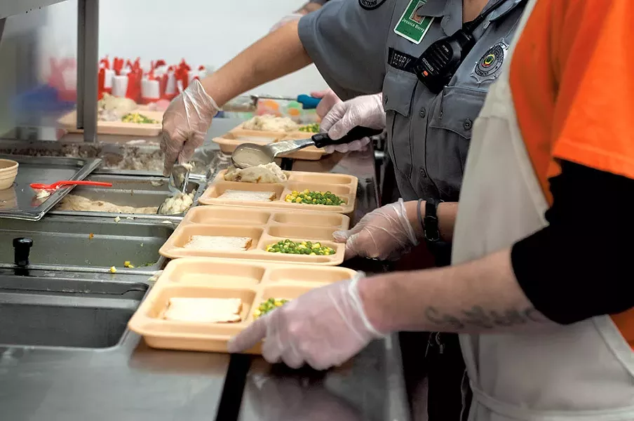 Preparing trays at Northeast Regional Correctional Facility - HANNAH PALMER EGAN