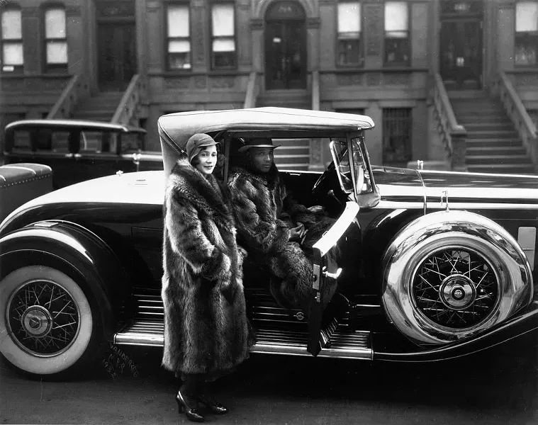 "A Harlem Couple Wearing Raccoon Coats Standing Next to a Cadillac on West 127th Street," photograph by James Van Der Zee - COURTESY OF MIDDLEBURY COLLEGE OF ART