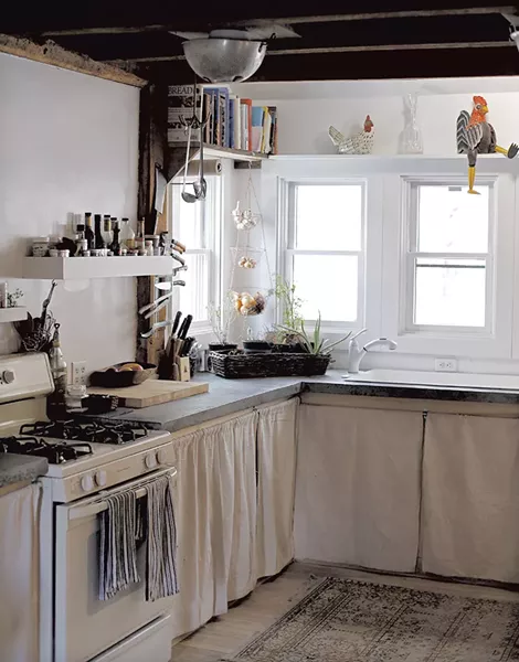 Hopkins and Meyerrose's remodeled kitchen features concrete countertops and a colander light fixture - SARAH PRIESTAP