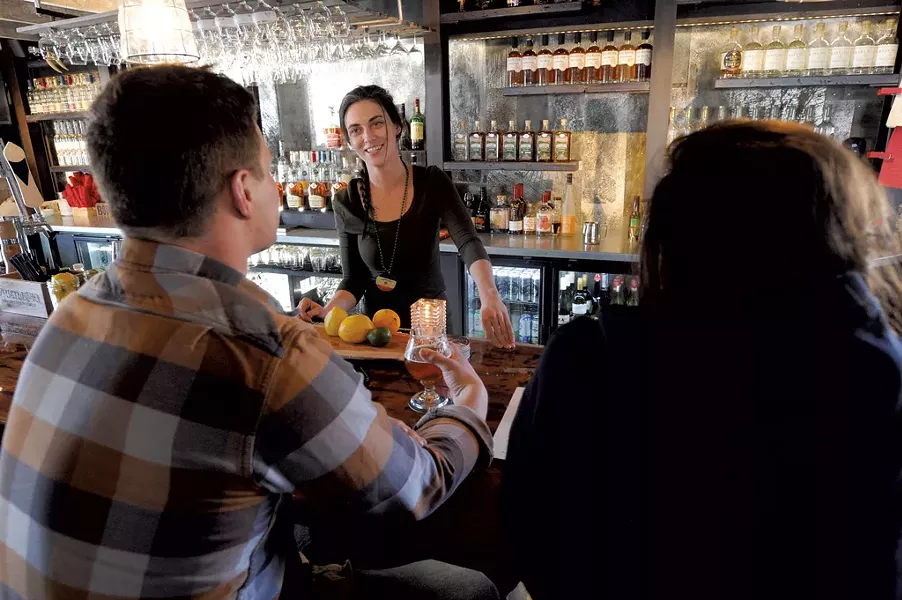 Emily Hassard visiting with bar customers - JEB WALLACE-BRODEUR