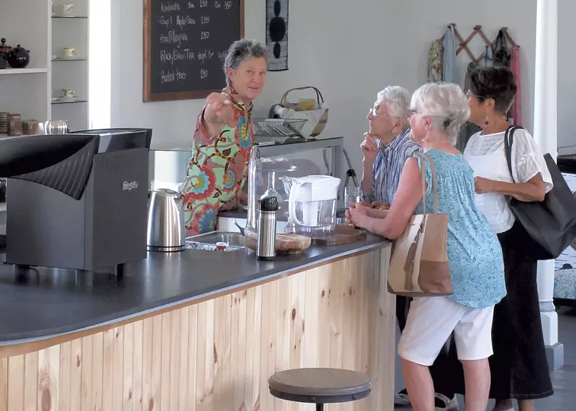 Diane Elliott Gayer serving visitors at GreenTARA Space - AMY LILY