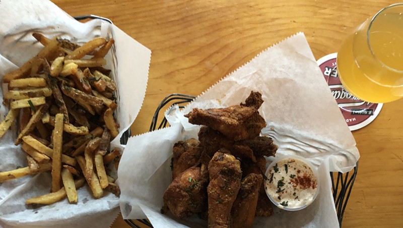Dry-rubbed chicken wings and fries at St. Paul Street Gastrogrub