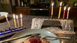 Latkes served on the third night of Hanukkah topped untraditionally with leftover Thanksgiving cranberry sauce.