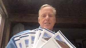 Former governor Howard Dean with multiple information booklets for new claimants that he received