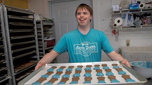 Co-owner Andrew Whiteford with a tray of dog treats