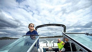 Champlain Fleet Club owners Tricia (captain) and Phil Scott (front right) cruising on Lake Champlain in Colchester with passengers