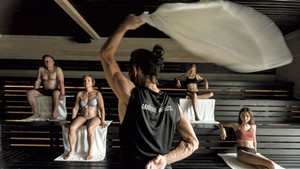 An aufgussmeister executing a German towel ritual in a sauna at F&ouml;rena Cit&eacute; Thermale