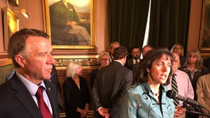 House Speaker Mitzi Johnson on Wednesday as Gov. Phil Scott looks on and Senate President Pro Tempore Tim Ashe (center) consults with colleagues