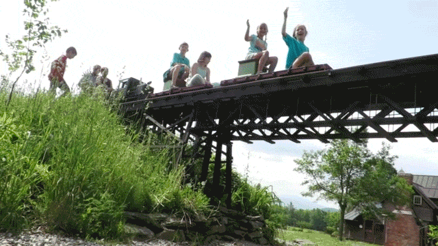 Mark Smith riding his train with student visitors - MATTHEW THORSEN