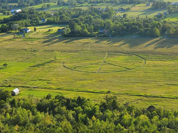 wtf who mowed a giant peace sign in a field next to mount philo live culture