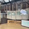Burlington City Hall is reflected in Good Times Gallery's window. Burlington City Hall is reflected in Good Times Gallery's window.