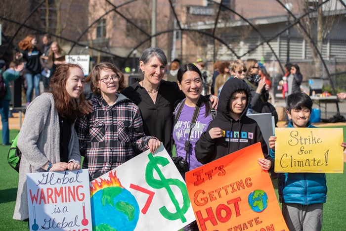 Dr. Heather Price (center left), a professor of chemistry at North Seattle College and climate scientist, poses for photos with attendees. She pushed back against people who said letting their children skip school is child abuse by listing the disasterous effects climate change will bring in the next few decades like water access, desertification, and rising sea levels. Thats child abuse!