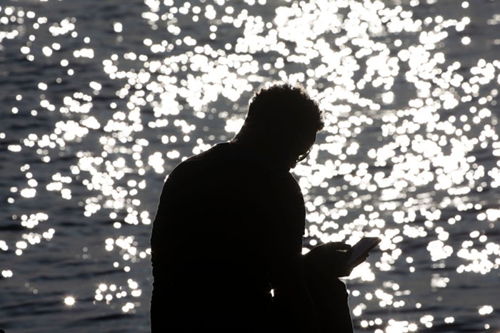 A man sitting on Alki beach. This kind of activity was banned over the weekend to inhibit the spread of coronavirus.