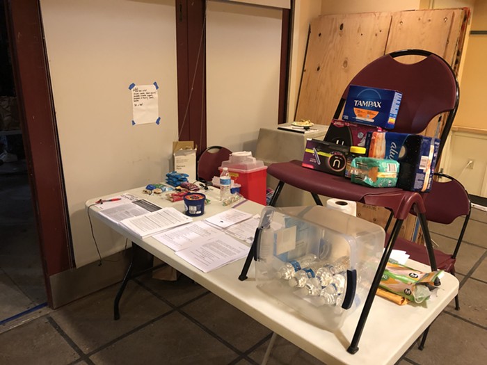 Heres the entryway. Papers on the table include information about sweeps, and the Shelterhouse Occupation Demands.