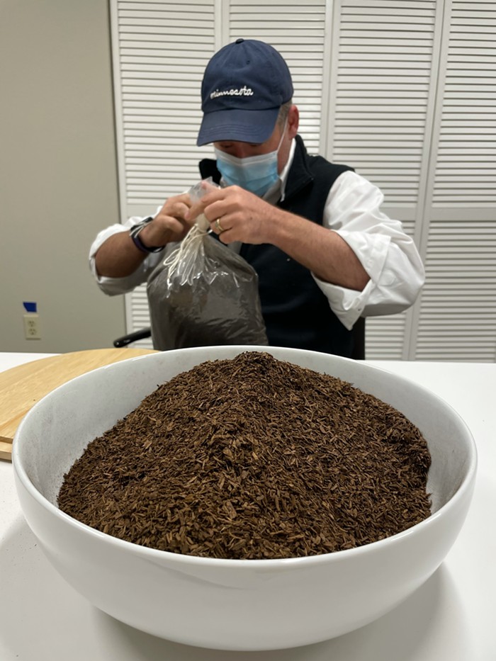 Return Home CEO Micah Truman opening up a bag of terramated compost.