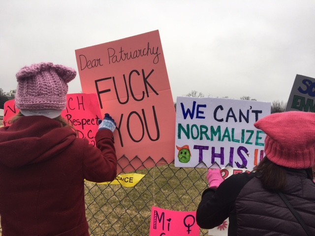 Signs left on the White House lawn fence.
