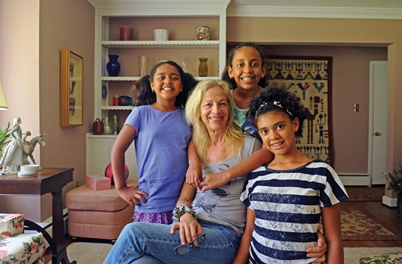 A decade after Ceil Gruessing spotted the three sisters Angie, Jazmin and Roxana, from left, in a cardboard box in Honduras, the new family has moved to Henrico County where the girls start school this week. - SCOTT ELMQUIST