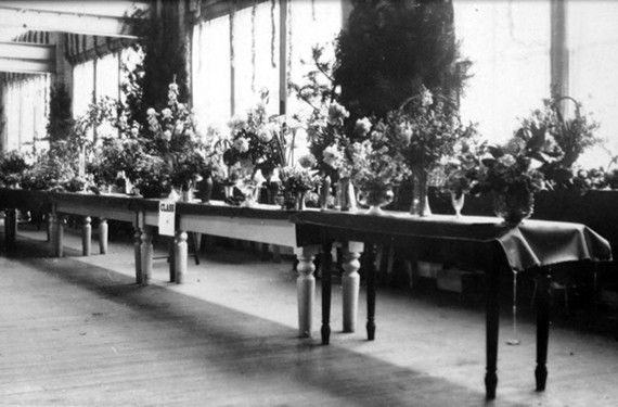 A rare interior view of the old Coliseum, now the Coliseum Lofts, located at 1367 W. Broad St. Harris Stilson and his wife, Mary, both enjoyed gardening and she may have had an entry in the flower competition shown in this undated photograph. - COPYRIGHT RICHMOND IN SIGHT