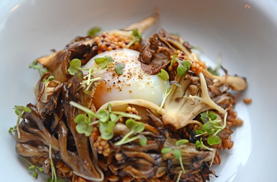 An egg from Harmony Hill Farms sits on top of rye berry risotto, and maitake and pickled enoki mushrooms. - SCOTT ELMQUIST