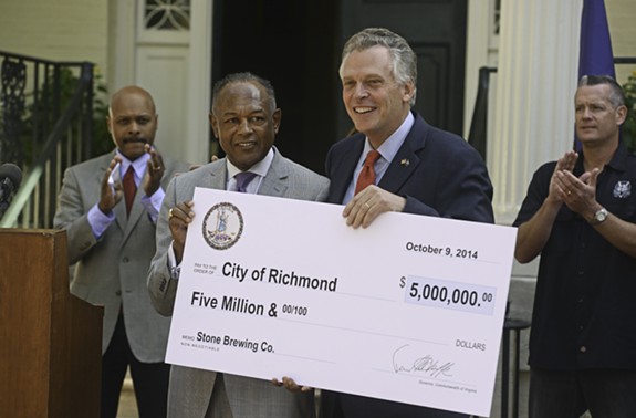 Gov. Terry McAuliffe presents Mayor Dwight Jones a check for $5 million in state incentives that will go toward bringing Stone Brewing Co. to Richmond. - SCOTT ELMQUIST