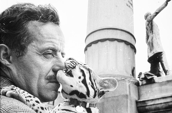 J. Peter Moore, Dali’s assistant, and the artist’s ocelot, Babou, posed for a photographer on Monument Avenue in April 1966 when Moore presented the artist’s concept for the Tompkins statue. - VCU LIBRARIES
