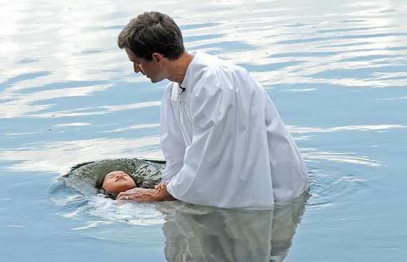 Leah Mei Ward, 8,  is baptized in the James River on July 17 by the Rev. Jim Somerville. - SCOTT ELMQUIST
