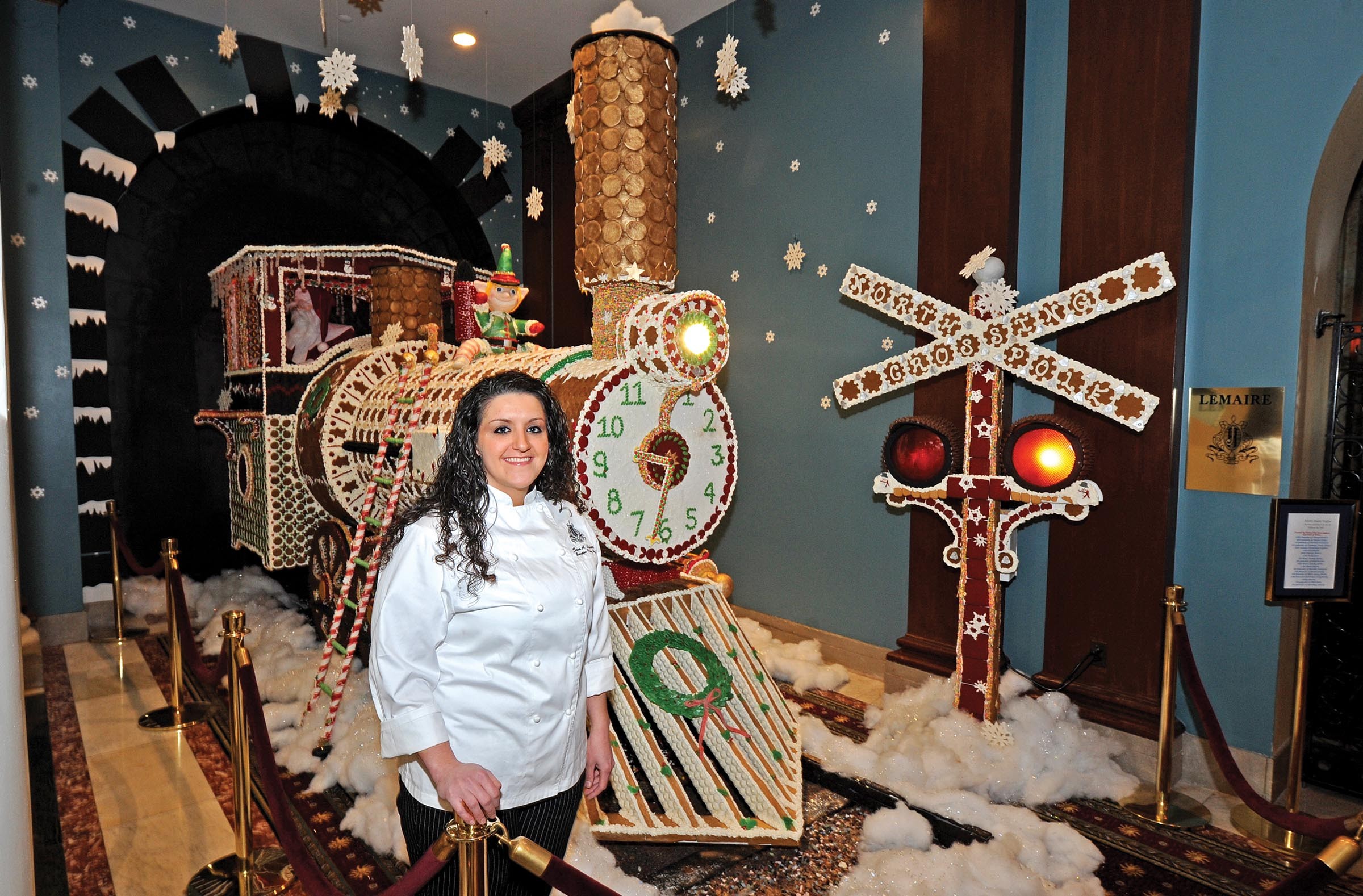 Sara Ayyash says it wasn't easy decorating Santa's steam engine at the Jefferson Hotel, but the results are a hit with visitors. Master carpenter Steve Corwin built the framework. - SCOTT ELMQUIST