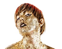 Singer Meghan Remy (U.S. Girls) is covered in gold flake by Canadian visual artist and fashion designer Renata Morales (Arcade Fire).