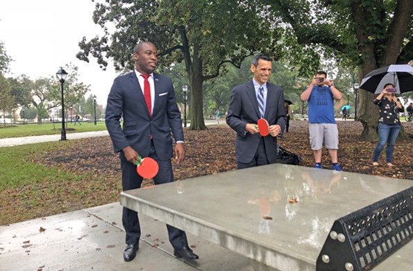 Ping-pong diplomacy: Mayor Levar Stoney and Michael Rao, VCU president, inaugurate the park’s table tennis amenity on Sept. 27. The city owns Monroe Park and the university will assist in maintaining it. - SCOTT ELMQUIST