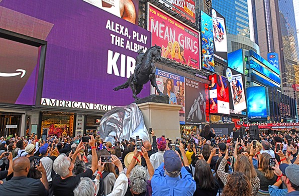 IPhones come out in Times Square as Kehinde Wiley, behind the speakers at right, unveils his bronze monument, “Rumors of War.” - SCOTT ELMQUIST