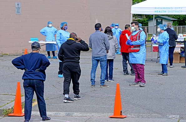 A team of health care workers from the Virginia Medical Reserve Corps administers COVID-19 tests near Creighton Court on April 28. - SCOTT ELMQUIST/FILE