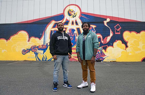 Capsoul Collective founders Eric Jackson and Tyrel Murdaugh stand before the Chris Visions mural behind Bingo Beer in Scott’s Addition.