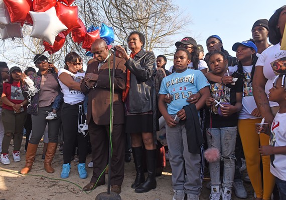 Charles Willis and Delores McQuinn, flanked by the family of the victims, led a prayer vigil for two teens killed in Mosby Court on Wednesday.