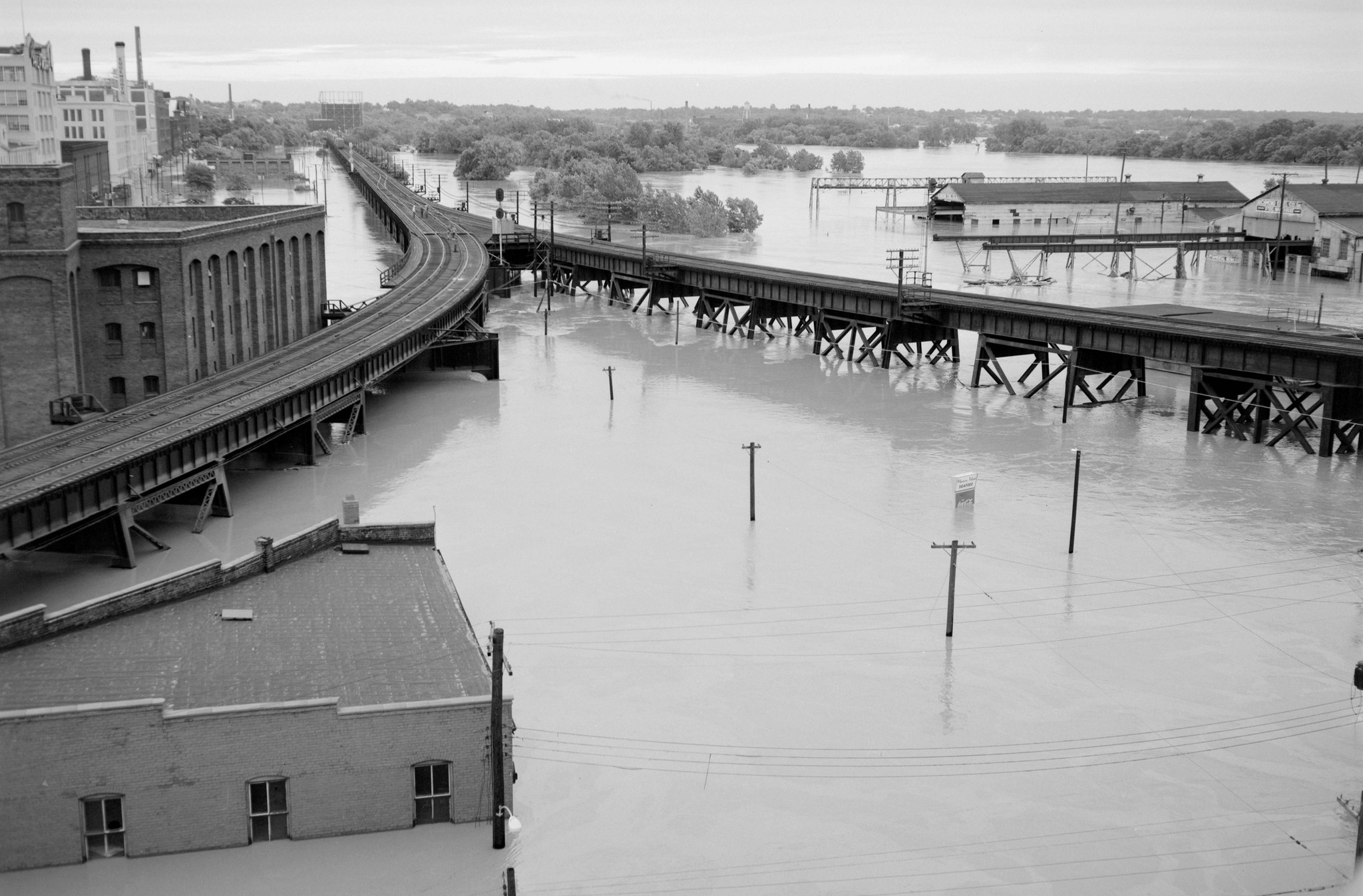 Flooding in Shockoe Bottom. This area was also flooded during Hurricane Gaston in 2004. The Bottom's Up Pizza Building is visible in the bottom left corner. - THE LIBRARY OF VIRGINIA