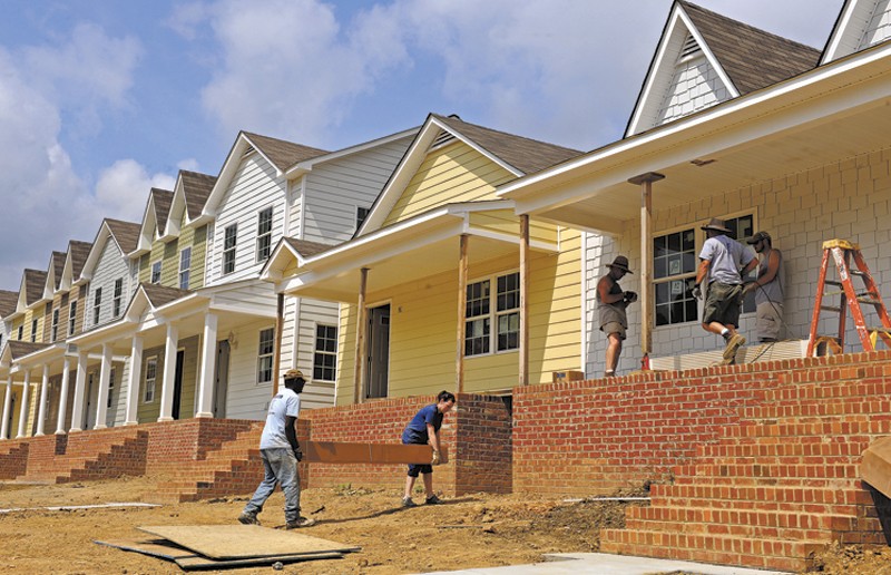 Volunteers work to finish the first houses in the Pillars at Oakmont development in Church Hill. - SCOTT ELMQUIST